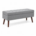 Banc de rangement en tissu gris avec pieds en bois